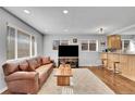 Cozy living room featuring a leather couch, wooden coffee table and an area rug at 4501 Bryant St, Denver, CO 80211