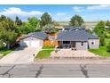 This property features a detached garage, driveway, and well-maintained yard at 1775 Longbranch St, Strasburg, CO 80136