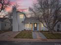 Charming exterior of a two-story home with walkway and a large tree at 2310 Willow Creek Dr, Golden, CO 80401