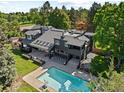 Expansive aerial view of home with a stunning backyard pool and outdoor lounge area at 1 Sedgwick Dr, Cherry Hills Village, CO 80113
