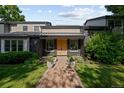 Charming home exterior featuring a welcoming brick pathway and well-maintained landscaping at 1 Sedgwick Dr, Cherry Hills Village, CO 80113