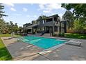 Beautiful backyard pool with diving board, set in a spacious and well-manicured lawn at 1 Sedgwick Dr, Cherry Hills Village, CO 80113