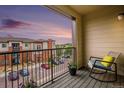 Relaxing balcony with rocking chair, offering a view of the parking lot at 14351 E Tennessee Ave # 305, Aurora, CO 80012