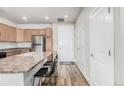 Modern kitchen with stainless steel appliances and an island at 14351 E Tennessee Ave # 305, Aurora, CO 80012
