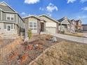 A inviting single-Gathering home, features a landscaped front yard and a spacious two-car garage at 8894 River Peak Cir, Littleton, CO 80125