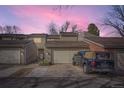 Charming townhome featuring a two-car garage with a vivid pink sky at 7925 W Layton Ave # 529, Littleton, CO 80123