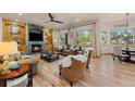 Cozy living room featuring a fireplace, built-in shelving, and large windows for abundant natural light at 7737 Taylor Cir, Larkspur, CO 80118