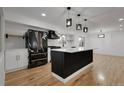 Modern kitchen features an island, stylish black and gold appliances, and sleek countertops at 2961 S Rosemary St, Denver, CO 80231