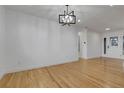Bright and spacious living room featuring hardwood floors, modern lighting, and freshly painted walls at 2961 S Rosemary St, Denver, CO 80231
