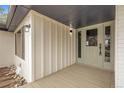 Covered front porch with modern lighting fixtures and ample space for welcoming guests at 2961 S Rosemary St, Denver, CO 80231
