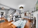 Inviting living room with a fireplace, built-in shelving, and staircase at 240 Colorado Blvd, Denver, CO 80206