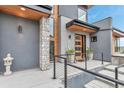 Inviting front porch with stone accents, stylish planters, and sleek metal railings at 202 October Pl, Castle Rock, CO 80104