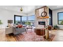 Bright living room featuring a stone fireplace, hardwood floors, and stunning views at 202 October Pl, Castle Rock, CO 80104
