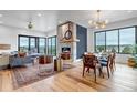 Elegant living room boasting a stone fireplace, hardwood floors, and scenic views at 202 October Pl, Castle Rock, CO 80104