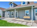 Inviting front porch with swing, potted plants, and stone accents at 177 W 8Th Ave, Byers, CO 80103