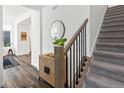 Bright entryway with wood floors, a staircase, and stylish decor at 1649 Marquette Aly, Erie, CO 80516