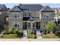 A well-maintained townhome with a gray roof, neat landscaping, and inviting front porches at 1649 Marquette Aly, Erie, CO 80516