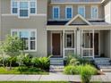 Charming townhome featuring a covered porch and well-kept lawn at 1649 Marquette Aly, Erie, CO 80516