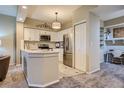 Bright kitchen with stainless steel appliances, white cabinets, backsplash, and pendant lighting at 6410 Silver Mesa Dr # B, Highlands Ranch, CO 80130