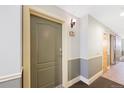 Hallway featuring neutral paint, trim, and door to unit 240 at 1560 Milwaukee St # 240, Denver, CO 80206