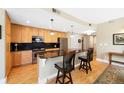 Open kitchen with granite countertops, stainless steel appliances, and a breakfast bar at 1560 Milwaukee St # 240, Denver, CO 80206