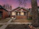 Charming brick home with a cozy front porch, perfect for enjoying the evening sunset at 361 S Logan St, Denver, CO 80209