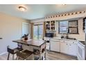 Functional kitchen featuring ample counter space, white cabinetry, and natural light at 2155 S Lewiston St, Aurora, CO 80013