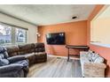 Cozy living room with neutral walls, light floors, and comfortable seating at 2155 S Lewiston St, Aurora, CO 80013