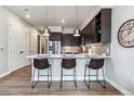 Eat-in kitchen island with comfortable seating and stylish pendant lighting, perfect for casual dining at 20 Wilcox St # 621, Castle Rock, CO 80104