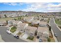 A neighborhood aerial shot shows a well-maintained area with mature trees and sidewalks near the foothills at 1811 Hogan Ct, Castle Rock, CO 80109