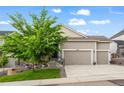 Charming two-story home with a well-manicured front lawn, three-car garage, and inviting front porch at 22669 E Tufts Pl, Aurora, CO 80015