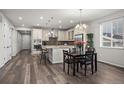 Open-concept kitchen features a large island, modern appliances, and stylish backsplash at 22669 E Tufts Pl, Aurora, CO 80015