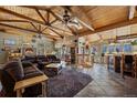 Spacious living room featuring a wood beamed ceiling, a stone fireplace, and stylish decor at 829 Colorado Blvd, Idaho Springs, CO 80452