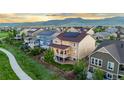 Beautiful home with a covered porch and mountain views shows off the neighborhood's serene setting at 19894 W 94Th Ln, Arvada, CO 80007