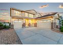 Spacious home with a three-car garage and a wide driveway shows off the home's curb appeal at 19894 W 94Th Ln, Arvada, CO 80007