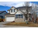 Charming two-story home featuring a brick facade, attached garage, and well-maintained landscaping at 1995 E 166Th Ave, Thornton, CO 80602