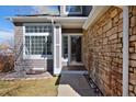 Welcoming front entrance featuring stone accents and a covered porch at 9436 Cody Dr, Broomfield, CO 80021