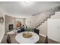Bright living room with a stylish fireplace, hardwood floors, and staircase at 2239 S Jasper Way # A, Aurora, CO 80013