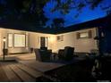 Exterior home view at twilight with front patio seating and manicured landscaping at 6537 Everett St, Arvada, CO 80004