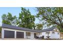 Charming exterior with white brick, modern dark trim, 2 car garage and inviting front patio at 6537 Everett St, Arvada, CO 80004