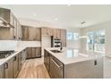 Bright, spacious kitchen featuring light-colored cabinets, a large island, modern appliances, and stylish countertops at 2750 E 102Nd Pl, Thornton, CO 80229