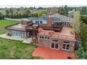 Exterior of the home showcasing a large deck, brick facade, and multiple windows for ample natural light at 8280 Queen St, Arvada, CO 80005