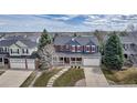 A bird's eye view of a two-story house with a well maintained yard in a suburban neighborhood at 10046 Brisbane Ln, Highlands Ranch, CO 80130