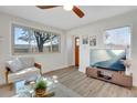 Cozy living room with a large window, modern furniture, and an entertainment center featuring a television at 1601 Robb St, Lakewood, CO 80215