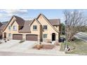 Inviting home features a two-car garage, stone accents, and a manicured front yard at 1890 Bel Lago Vw, Monument, CO 80132