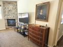 Comfortable living room showcasing a stone fireplace, TV, and stylish decor at 1890 Bel Lago Vw, Monument, CO 80132