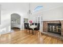 Formal dining room with hardwood floors, fireplace, and a large window letting in natural light at 2208 S Eldridge Ct, Lakewood, CO 80228