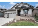 Charming two-story home featuring stone accents and a three-car garage in a well-kept neighborhood at 15784 Burrowing Owl Ct, Morrison, CO 80465