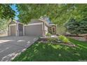 Charming home featuring a three-car garage, well-manicured lawn, and attractive landscaping at 8196 Wetherill Cir, Castle Pines, CO 80108