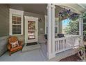 Cozy front porch with comfortable seating, decorative plants, and a welcoming entrance at 8196 Wetherill Cir, Castle Pines, CO 80108